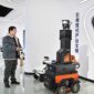 A staff member of Tianjin Siasun Intelligent Technology operates a mine inspection robot in the Beijing-Tianjin Zhongguancun Tech Town in Tianjin.