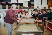 H.E. Mr. Karlis Eihenbaums，ambassador of Latvia to China, tries his hand at the traditional craft of Xuan papermaking.